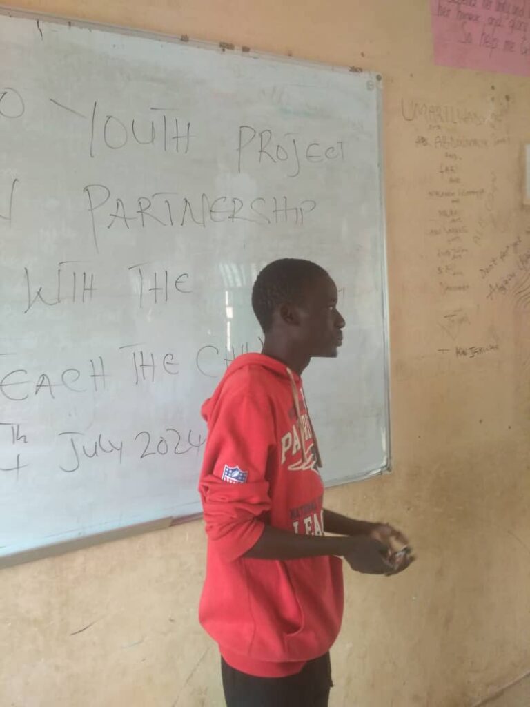 Ibrahim, a deaf youth advocate, is speaking to students in a classroom in Kaduna.